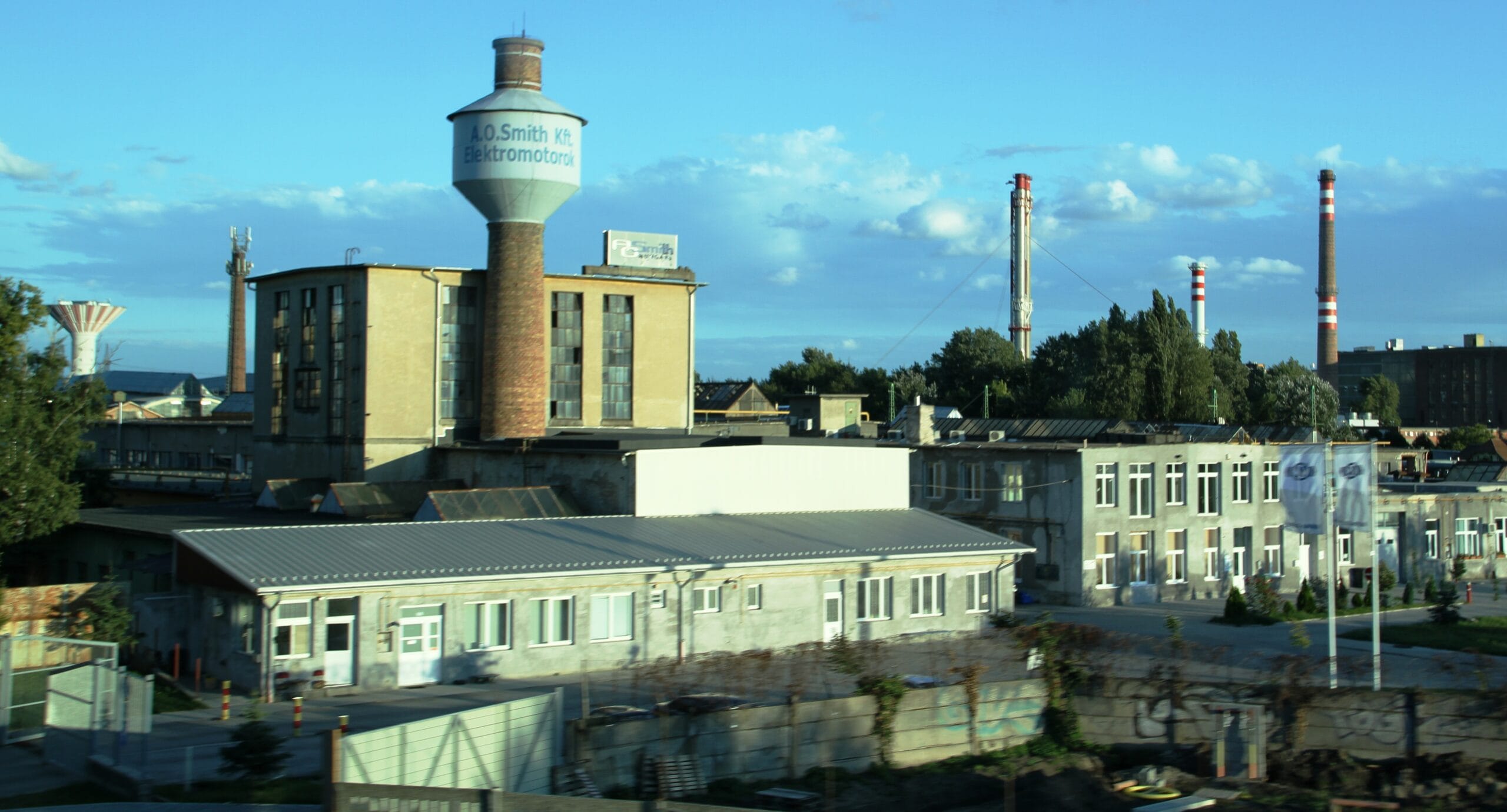 The Evig Invest Industrial Park with an A.O. Smith Hungary Kft. advertisement (former United Electrical Machinery Factory - Egyesült Villamos Gépgyár (EVIG) - a